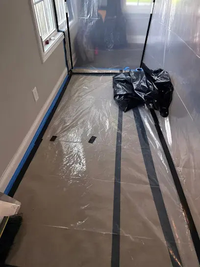 Plastic containment and bagged debris during a water damage cleanup