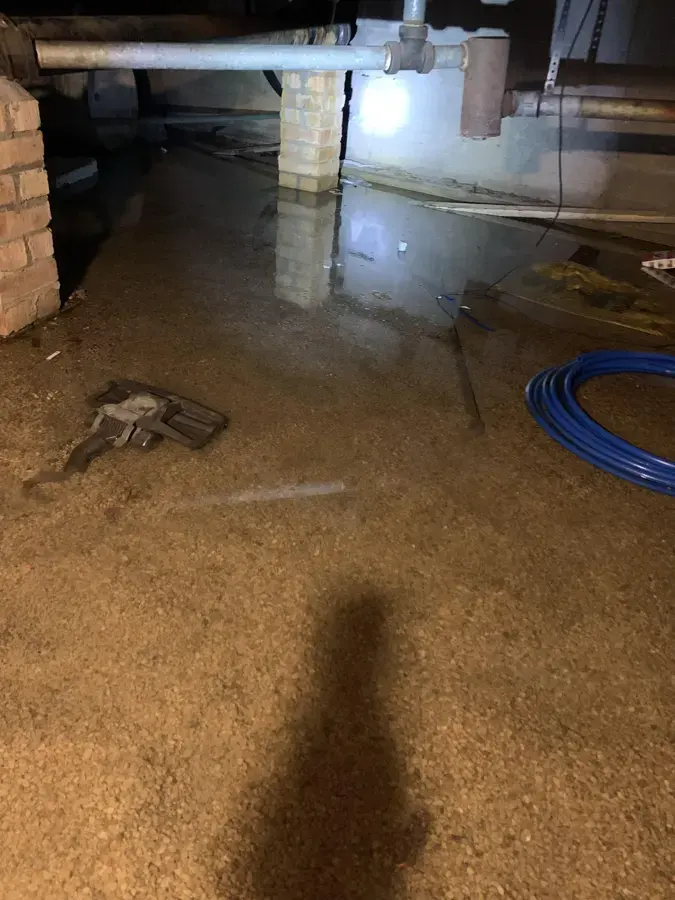 Standing water in a crawl space under a house