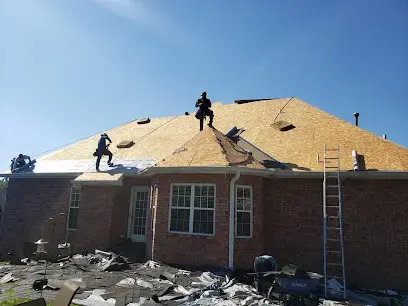 Roofers working on the roof of a brick ranch home after storm damage
